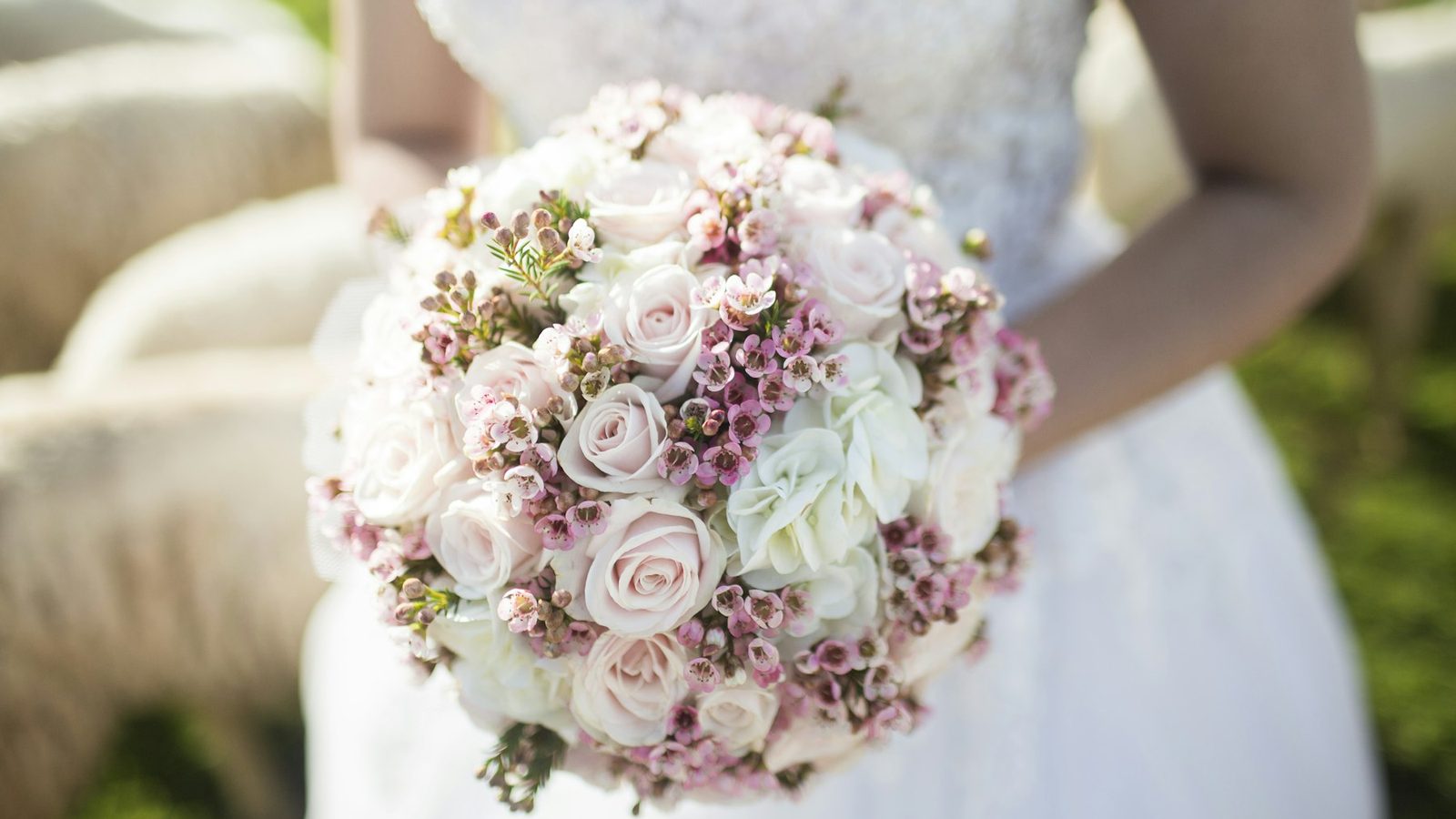 Bride holding a blush pink and white wedding bouquet